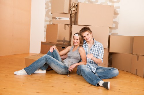 Local removals team carrying furniture through a Southwark property