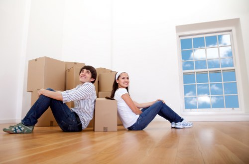 Trained movers using safe lifting techniques inside a property