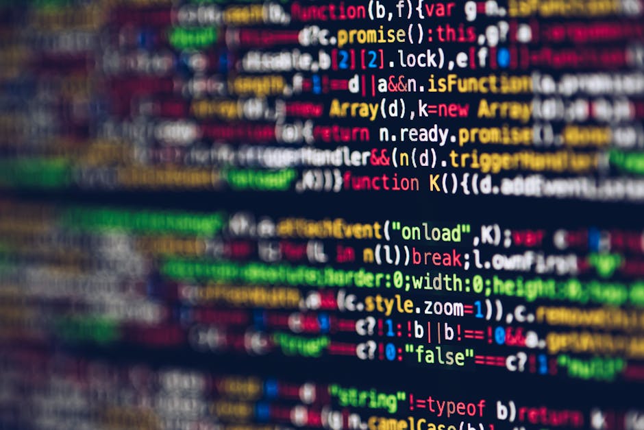 Close-up view of a computer screen displaying multicolored lines of code, including keywords, functions, variables, and syntax in various colors such as red, green, blue, and yellow. The code is sligh